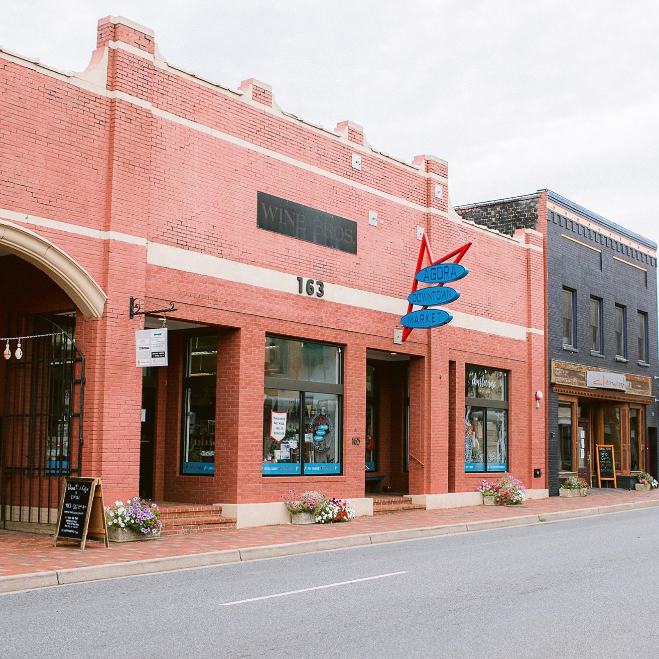 The street view of Agora downtown market, made up of red brick and large windows.