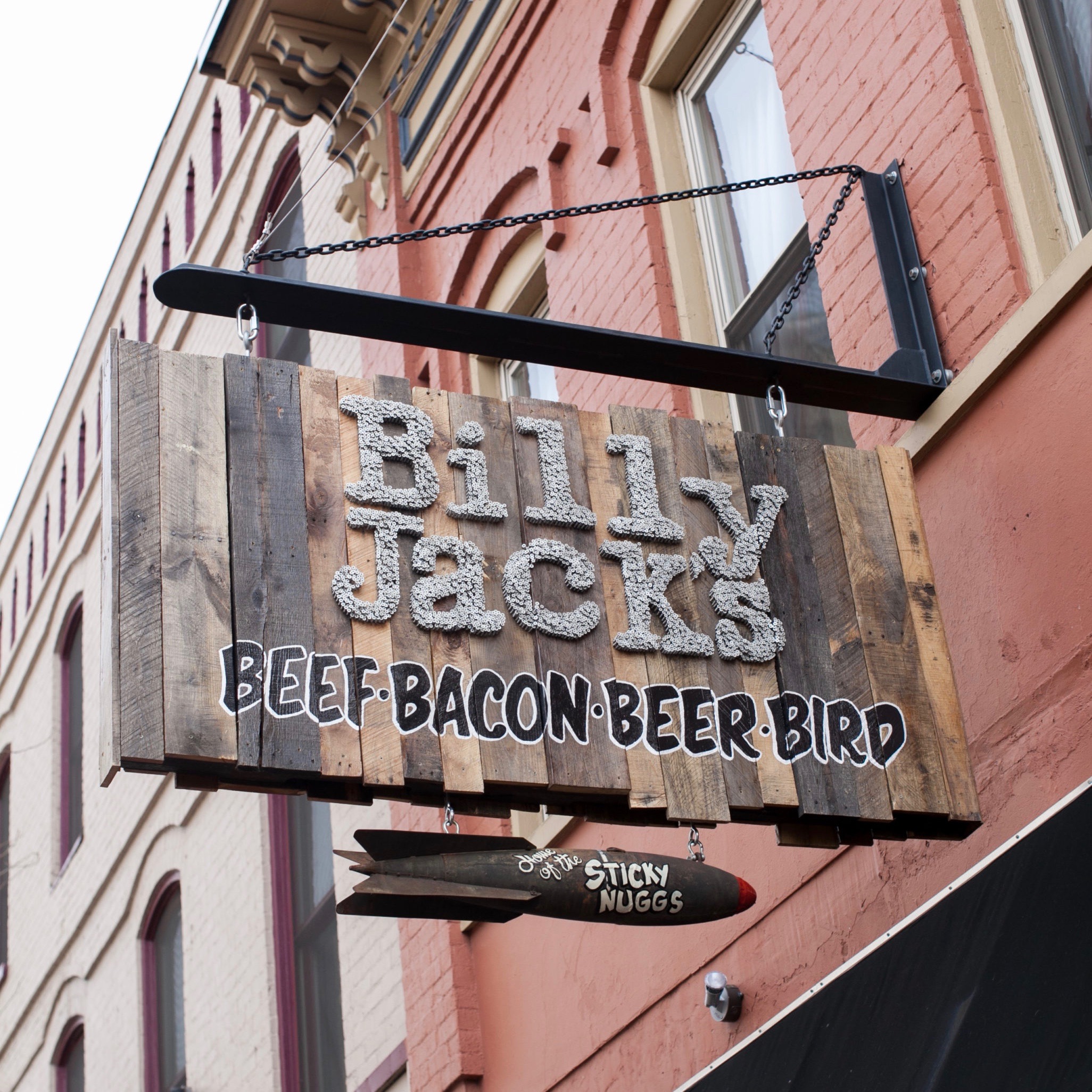 The hanging, wooden street sign of Billy jack's shack.