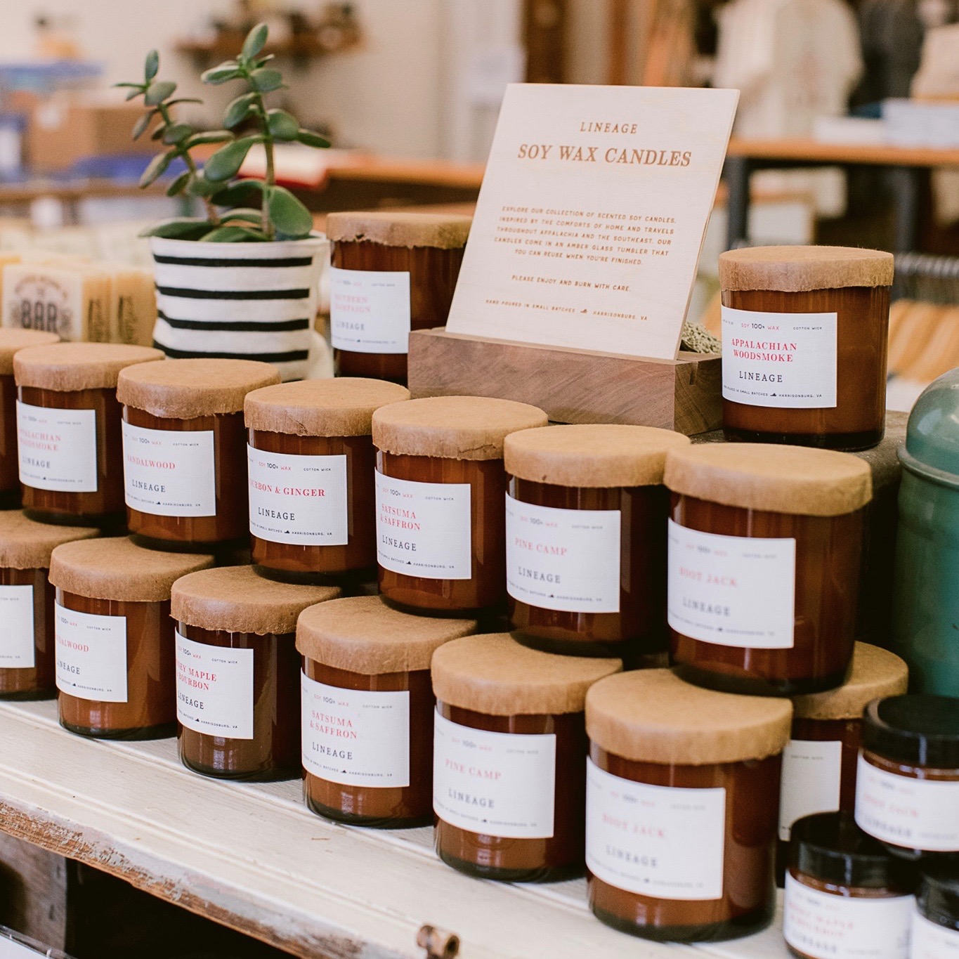 Twenty stacked candles on a stand with signage indicating the name of the product.