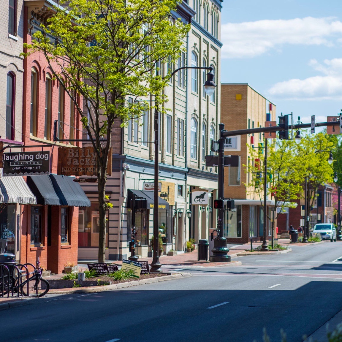 South Main street during the spring in downtown Harrisonburg, lined with trees, shops and restaurants.