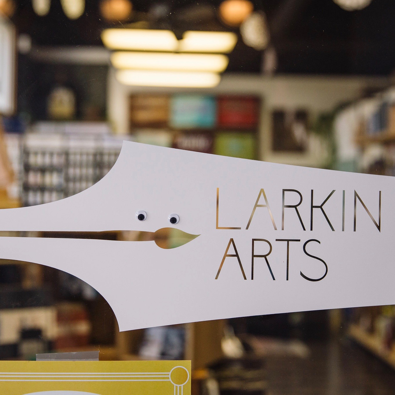 The Larkin arts logo on the glass doors of the store.